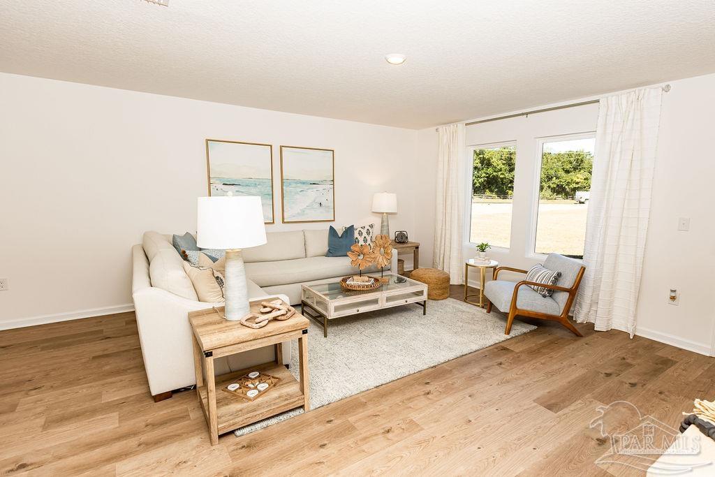 4731 Bald Eagle Road Pace, FL 32571 - Photo 6 of 19 a living room with furniture and a table
