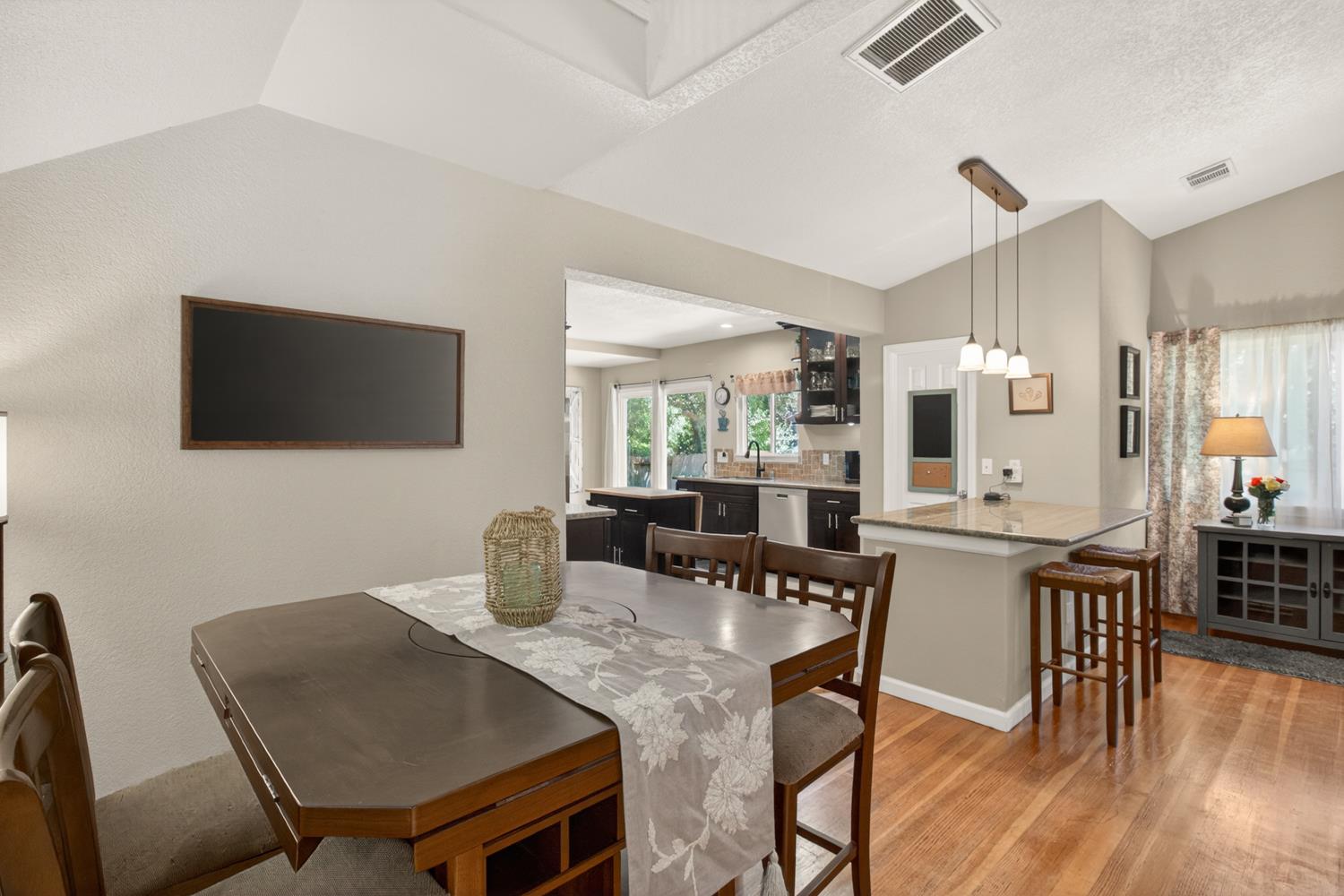 6332 Horseshoe Bar Road Loomis, CA 95650 - Photo 14 of 85 Open-concept dining area featuring wood-finish flooring and a vaulted ceiling