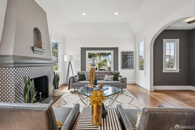 a living room with furniture and a fireplace