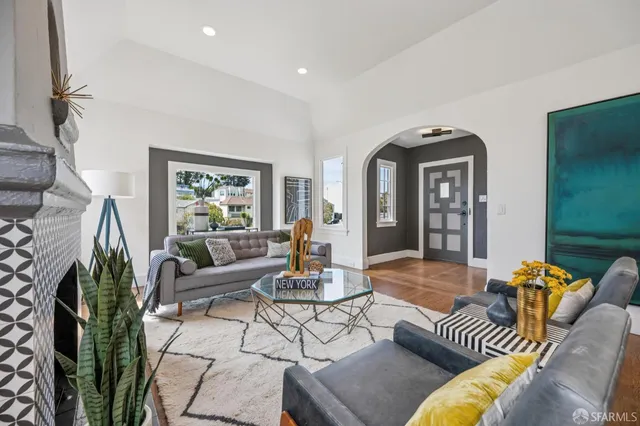 a living room with furniture fireplace and a chandelier