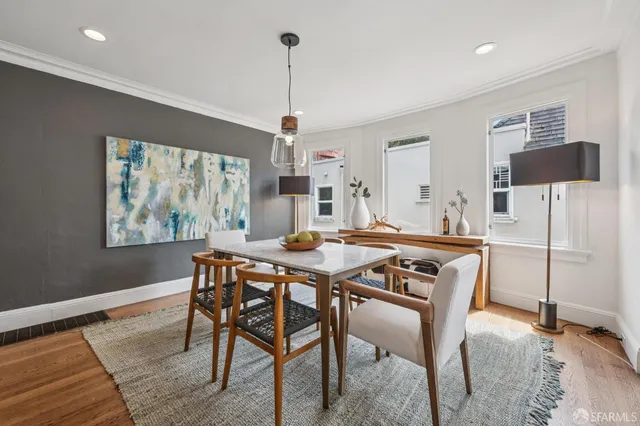 a view of a dining room with furniture and wooden floor
