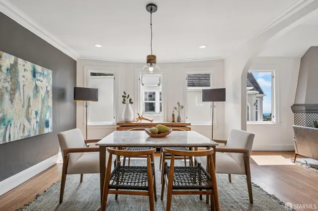 a kitchen with granite countertop a dining table chairs and wooden floor