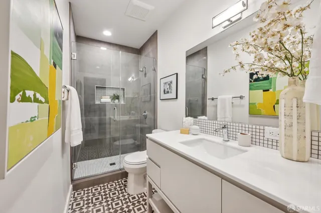 a bathroom with a sink toilet and shower