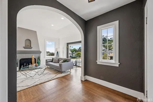 a living room with furniture a fireplace and a table