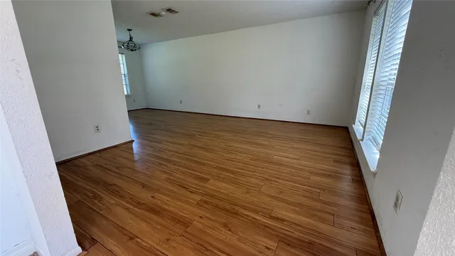 an empty room with wooden floor