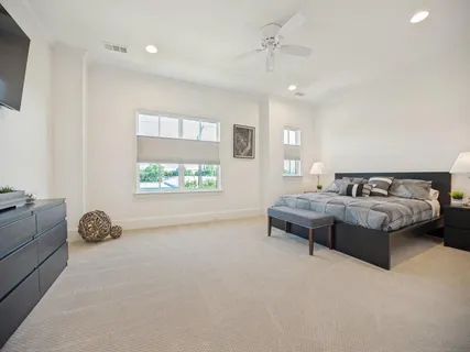 a spacious bedroom with a bed and a couch