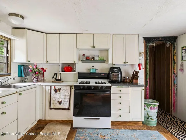 a kitchen with stainless steel appliances a stove top oven and cabinets