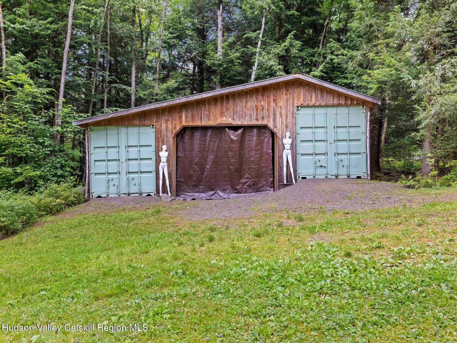 325 Brand Road Conesville, NY 12076 - Photo 29 of 36 a view of backyard with small cabin and wooden fence