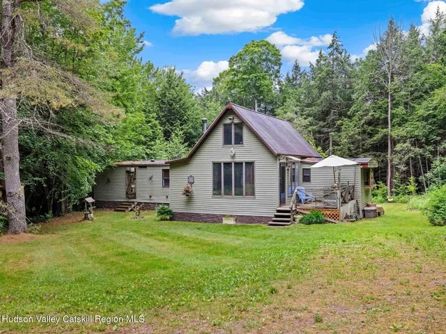 a house view with a sitting space and garden