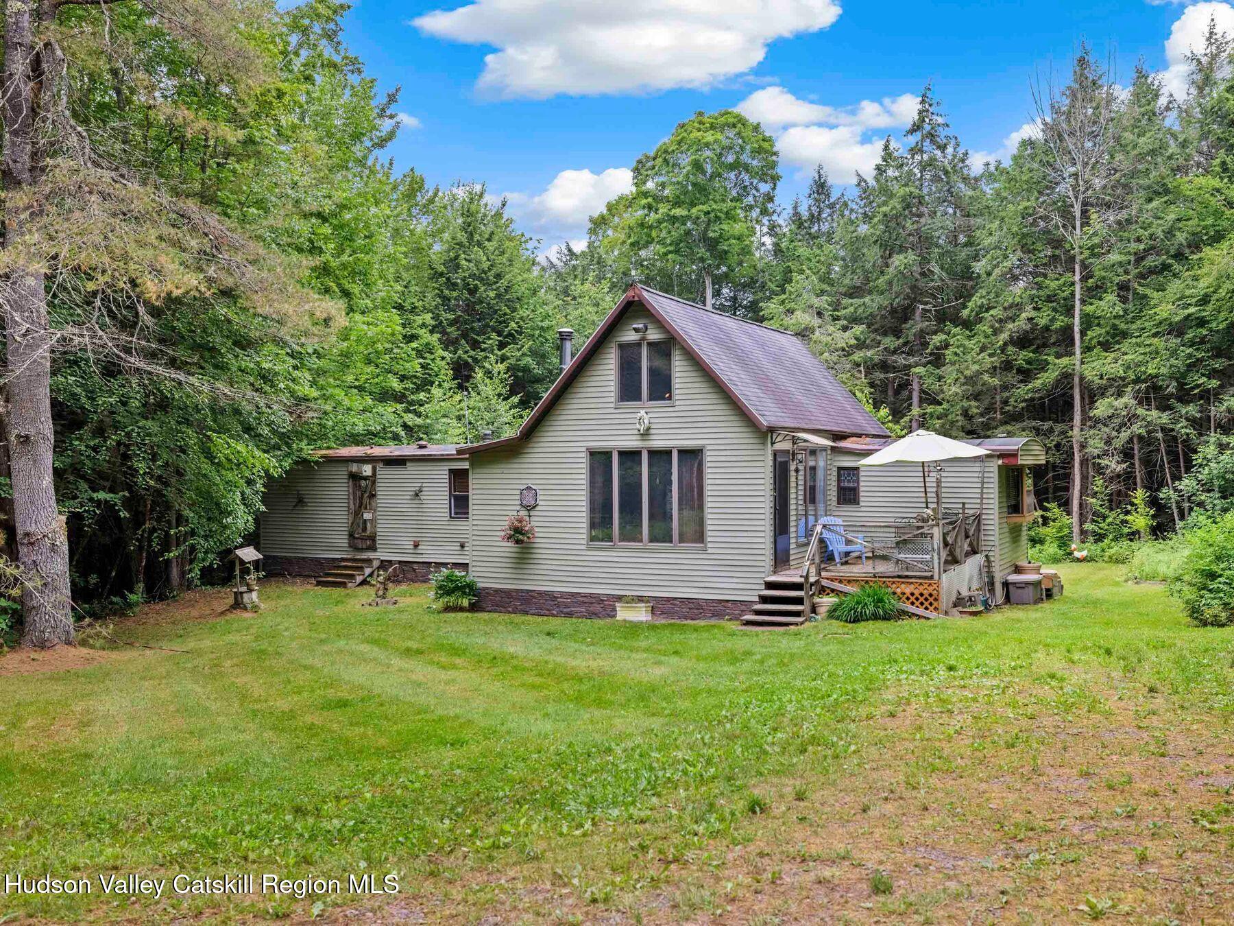 325 Brand Road Conesville, NY 12076 - Photo 3 of 36 a house view with a sitting space and garden