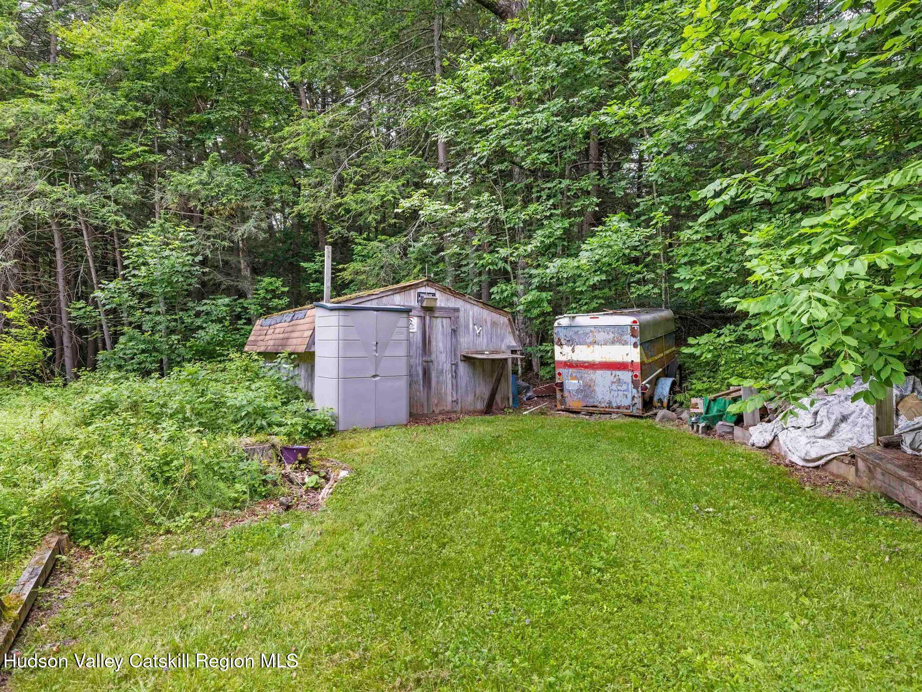 325 Brand Road Conesville, NY 12076 - Photo 32 of 36 a backyard of a house with seating space