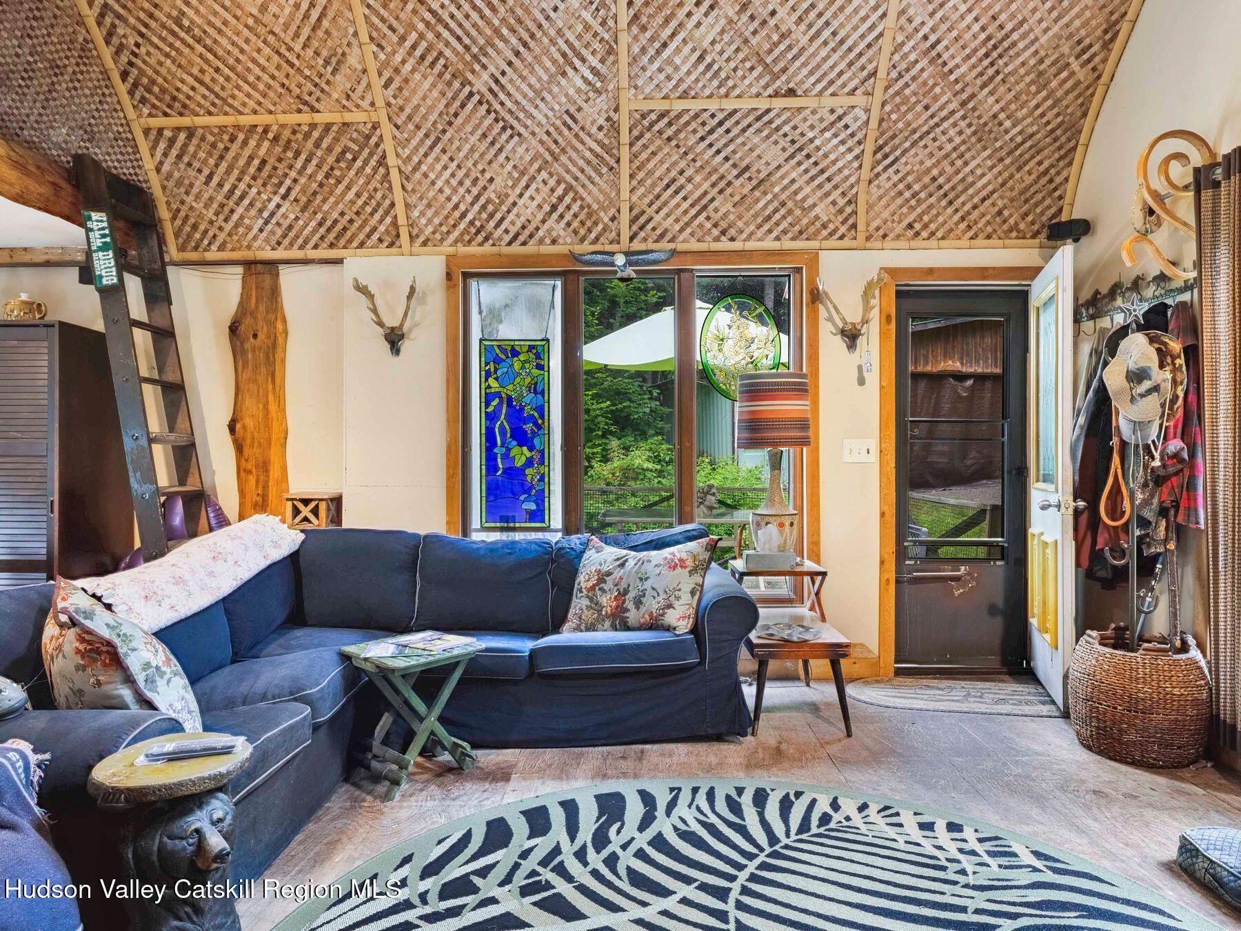 325 Brand Road Conesville, NY 12076 - Photo 8 of 36 a living room with furniture and a large window