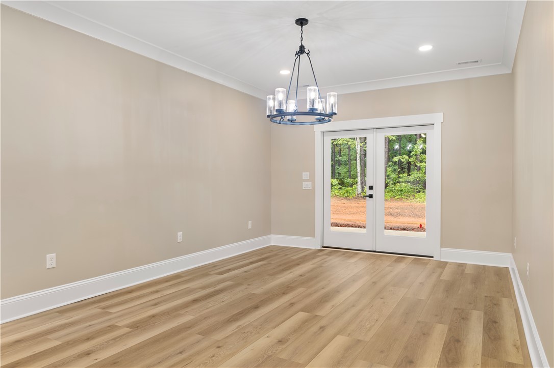 147 McAlister Road West Union, SC 29696 - Photo 12 of 49 This bright room features a modern light fixture and direct outdoor access through elegant glass doors.