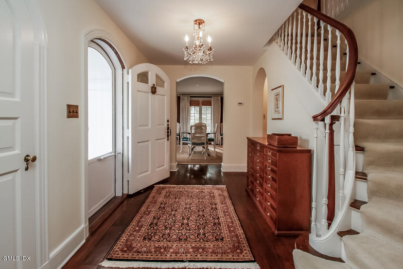 35 Willow Road Riverside, CT 06878 - Photo 5 of 35 a living room with a rug and a chandelier