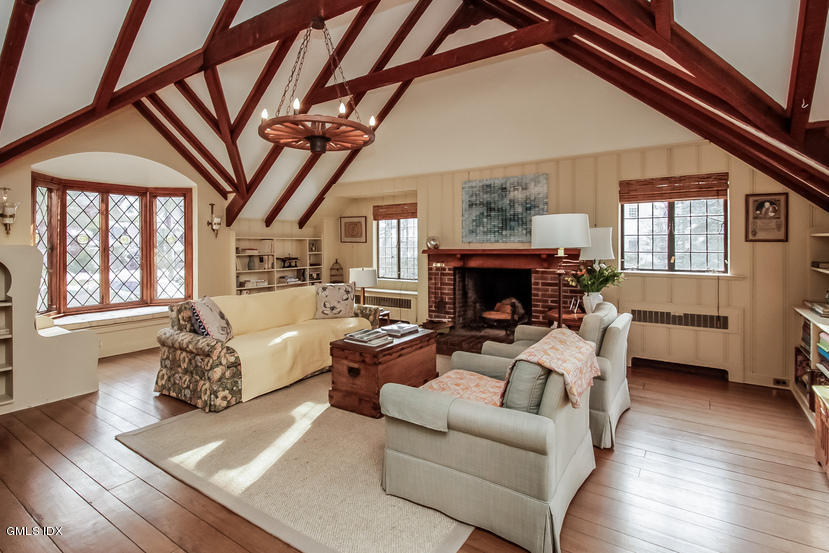 35 Willow Road Riverside, CT 06878 - Photo 6 of 35 a living room with furniture a fireplace and a large window
