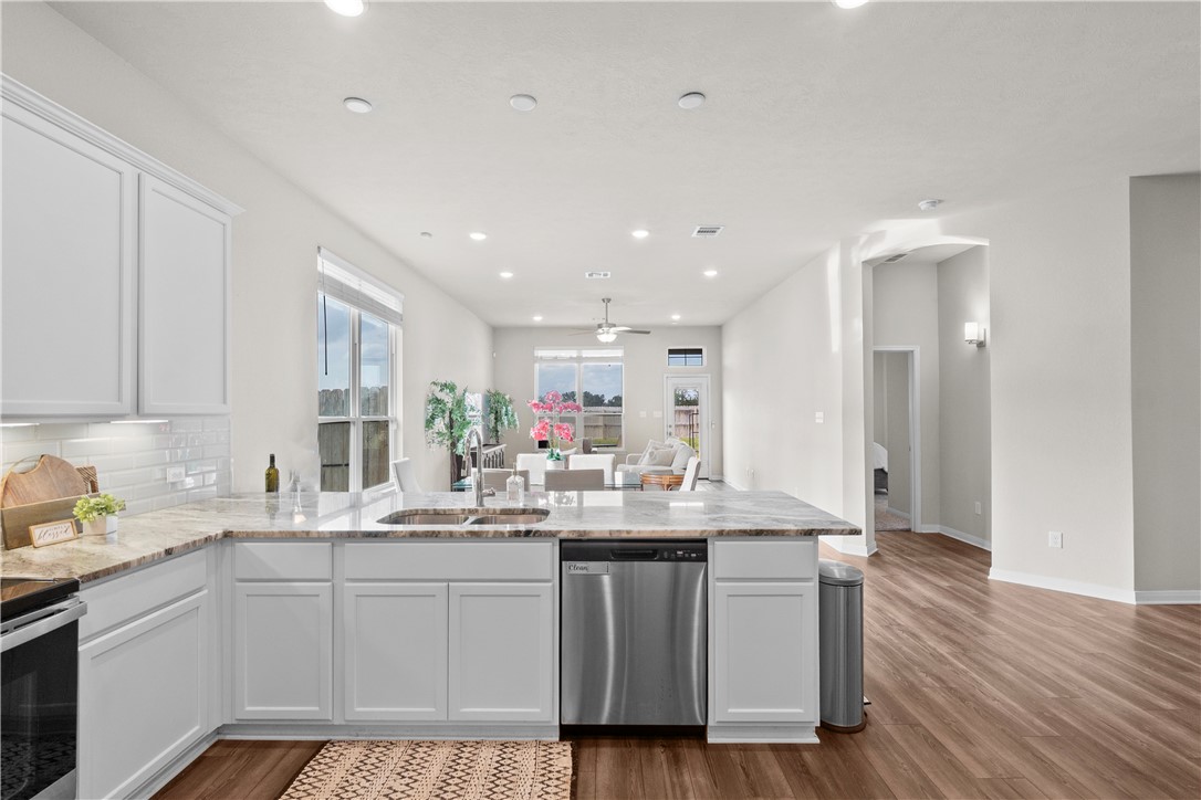 1932 Viva Road Bryan, TX 77807 - Photo 37 of 38 Kitchen with open floor plan, walk in pantry, white cabinets, stainless appliances, and light granite counters