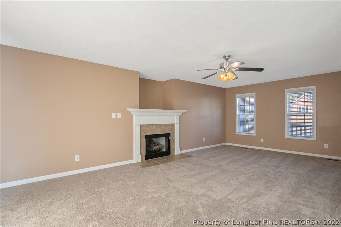 38 Rockingham Street Spring Lake, NC 28390 - Photo 12 of 50 a view of an empty room with chandelier fan and fire place