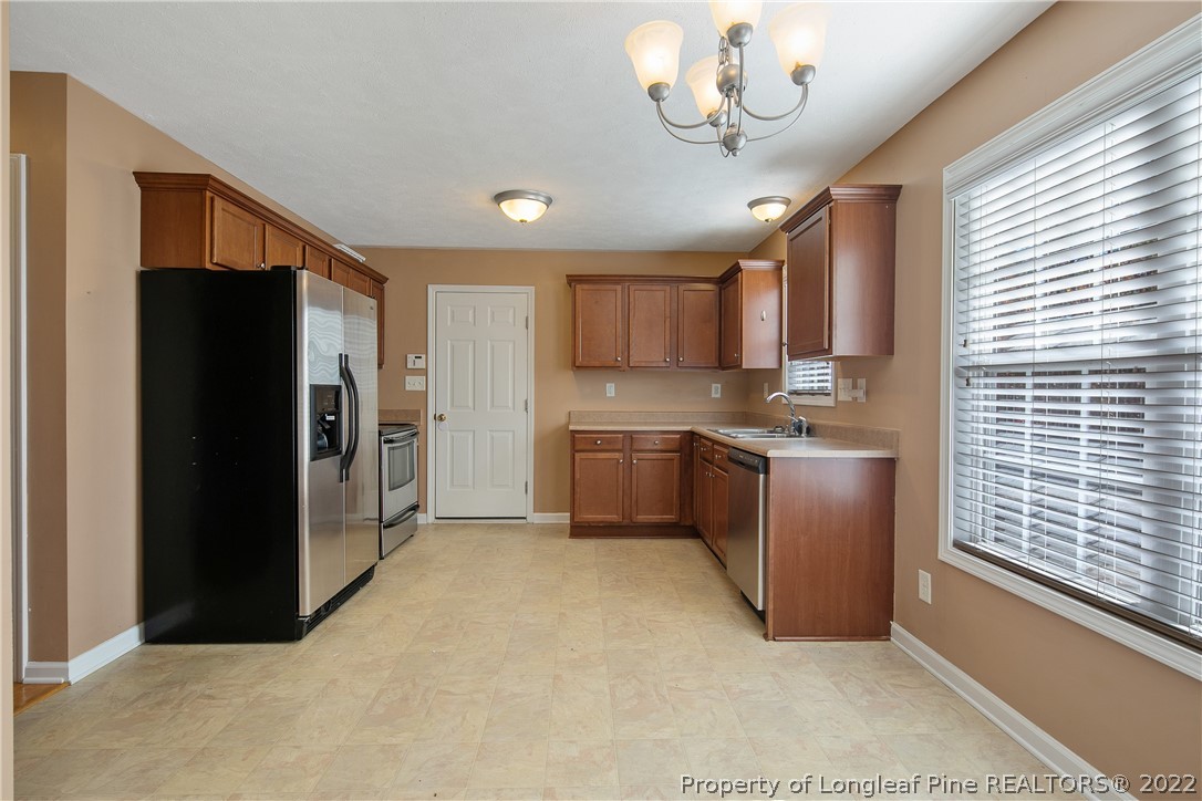 38 Rockingham Street Spring Lake, NC 28390 - Photo 15 of 50 a kitchen with a refrigerator a sink and cabinets