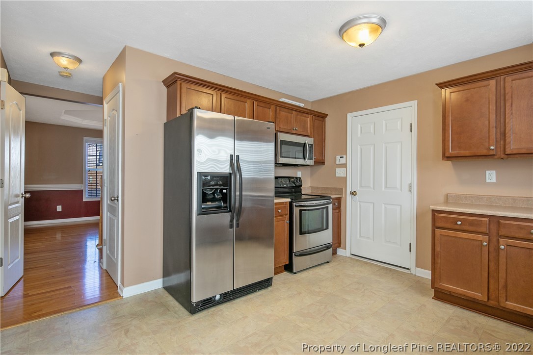 38 Rockingham Street Spring Lake, NC 28390 - Photo 19 of 50 a kitchen with stainless steel appliances granite countertop a refrigerator and a stove