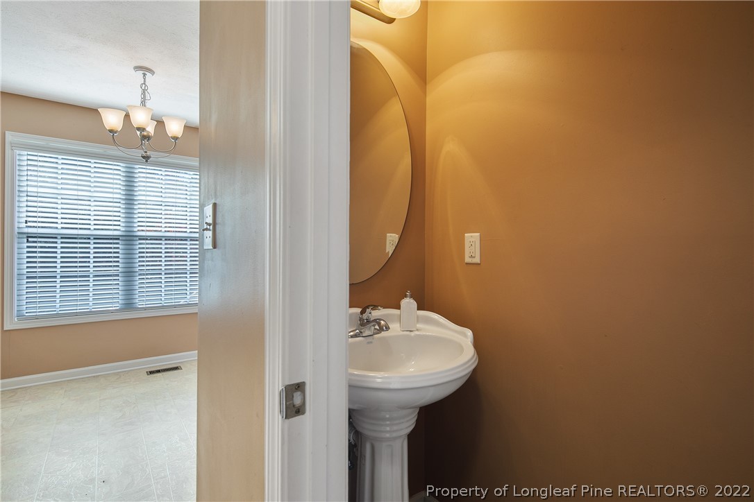38 Rockingham Street Spring Lake, NC 28390 - Photo 22 of 50 a bathroom with a sink a mirror and a toilet
