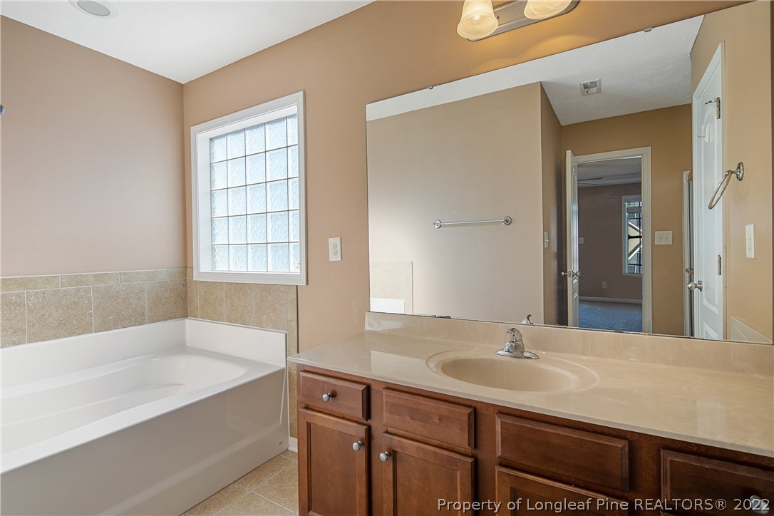 38 Rockingham Street Spring Lake, NC 28390 - Photo 29 of 50 a bathroom with a tub sink and mirror
