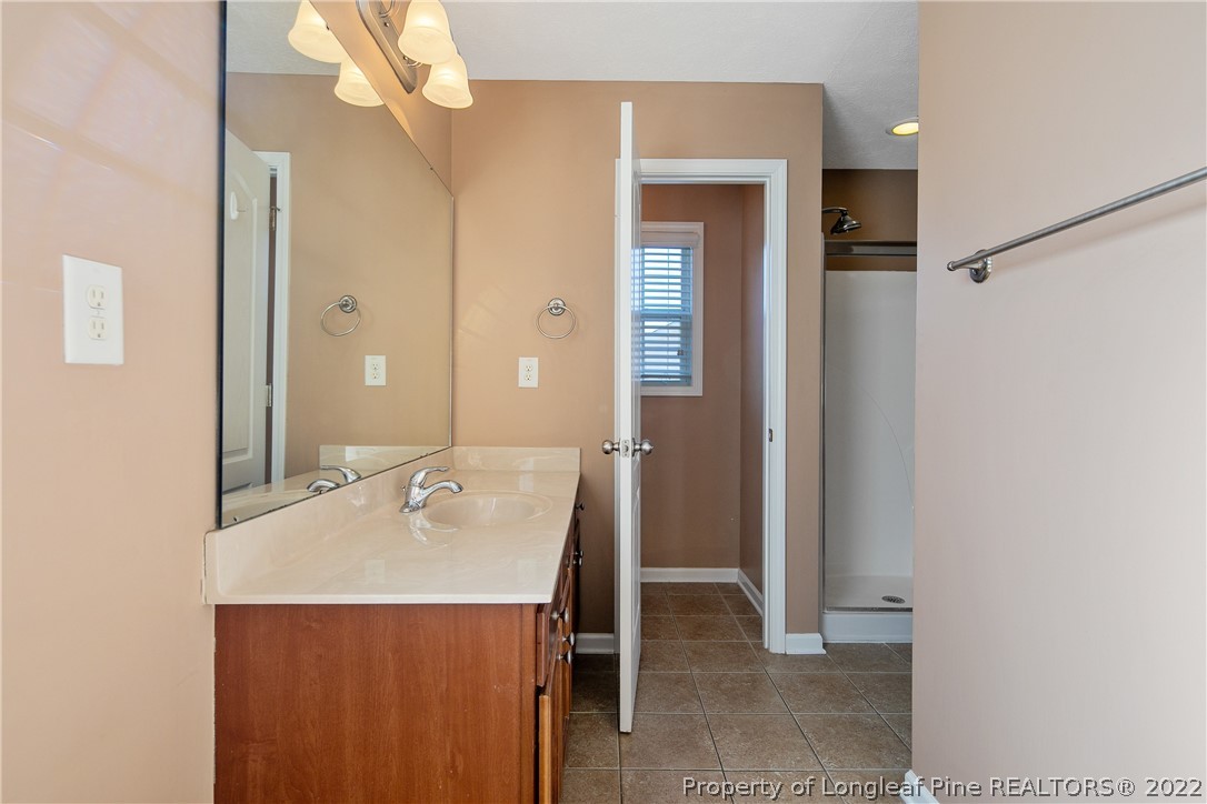 38 Rockingham Street Spring Lake, NC 28390 - Photo 30 of 50 a bathroom with a sink and a mirror