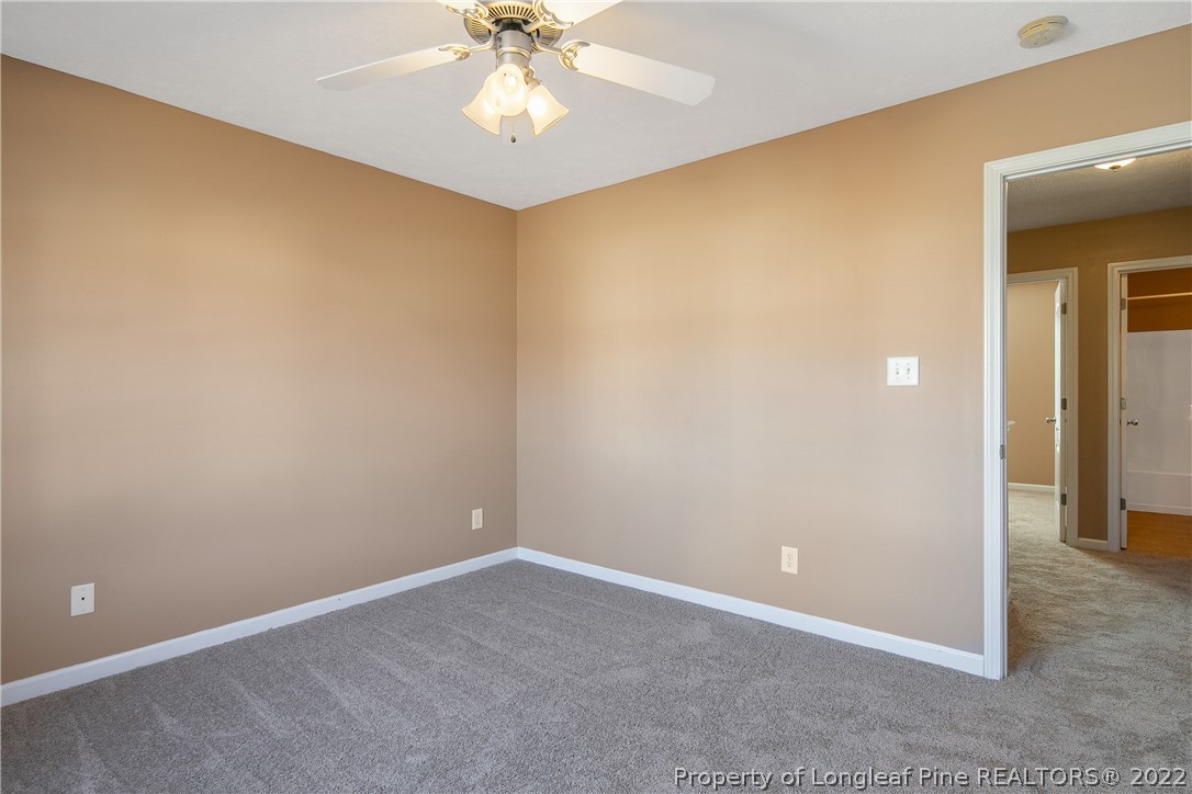 38 Rockingham Street Spring Lake, NC 28390 - Photo 39 of 50 an empty room with a chandelier fan and closet area