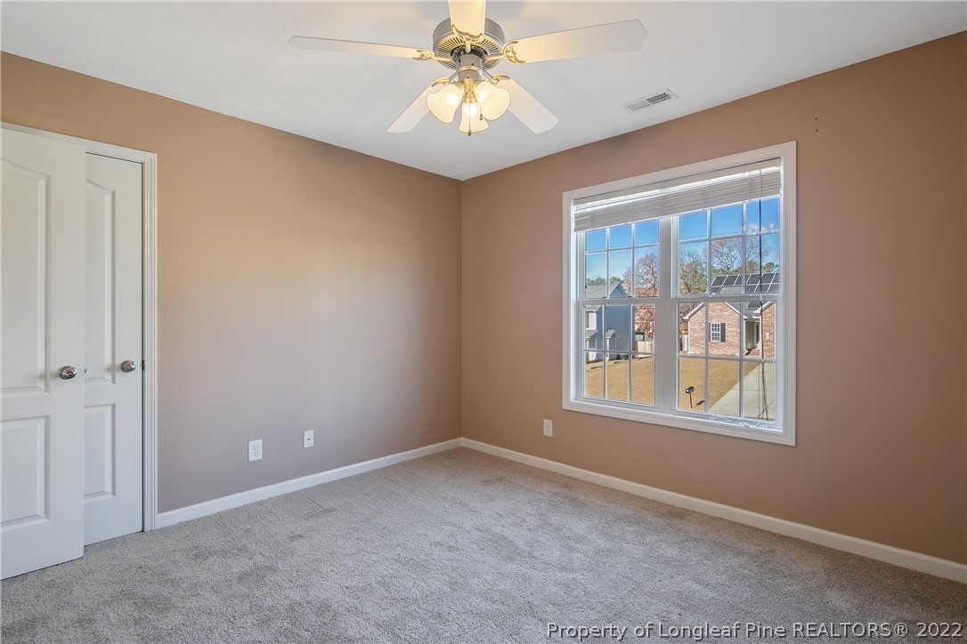 38 Rockingham Street Spring Lake, NC 28390 - Photo 41 of 50 an empty room with windows and chandelier fan