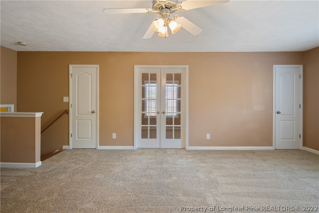 38 Rockingham Street Spring Lake, NC 28390 - Photo 44 of 50 a view of an empty room with window and chandelier fan