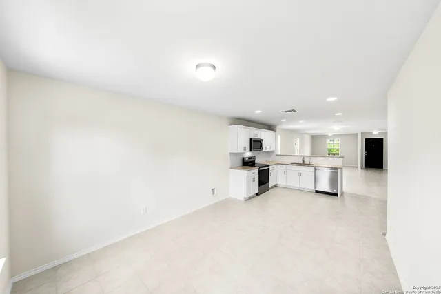a view of kitchen with furniture and refrigerator