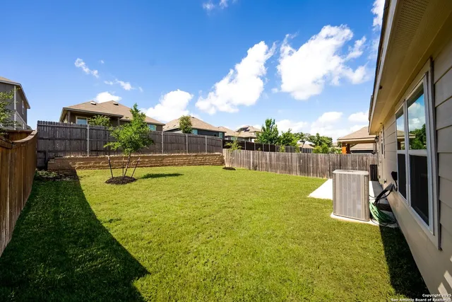 a swimming pool with outdoor seating and yard