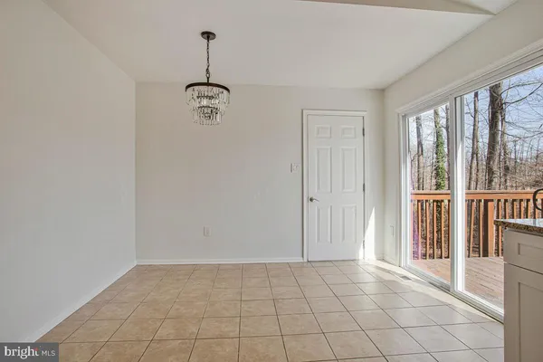 a view of an empty room with glass door