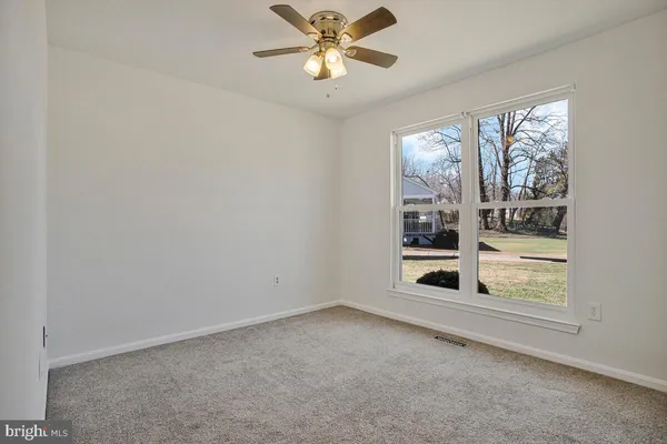a view of room with window and ceiling fan