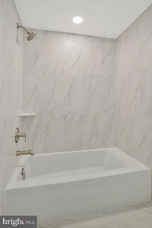 a bathroom with a bathtub and a shower