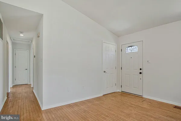 a view of an empty room and wooden floor