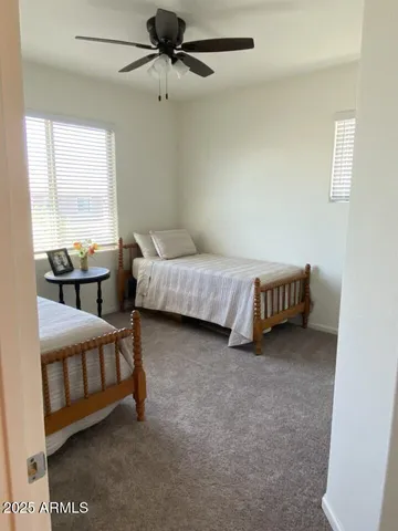 a living room with furniture and a ceiling fan