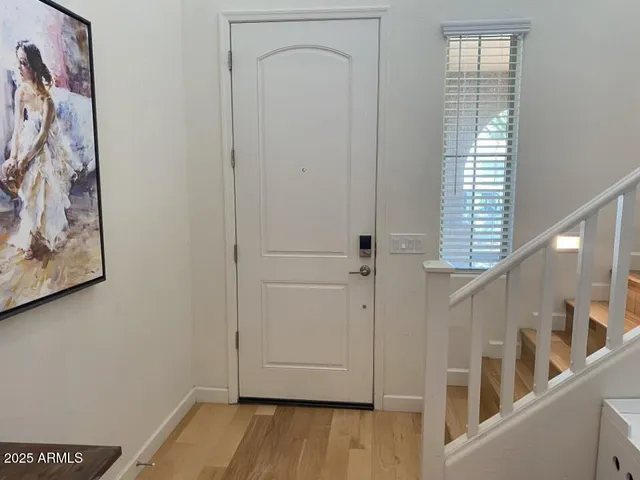 a view of an entryway with wooden floor