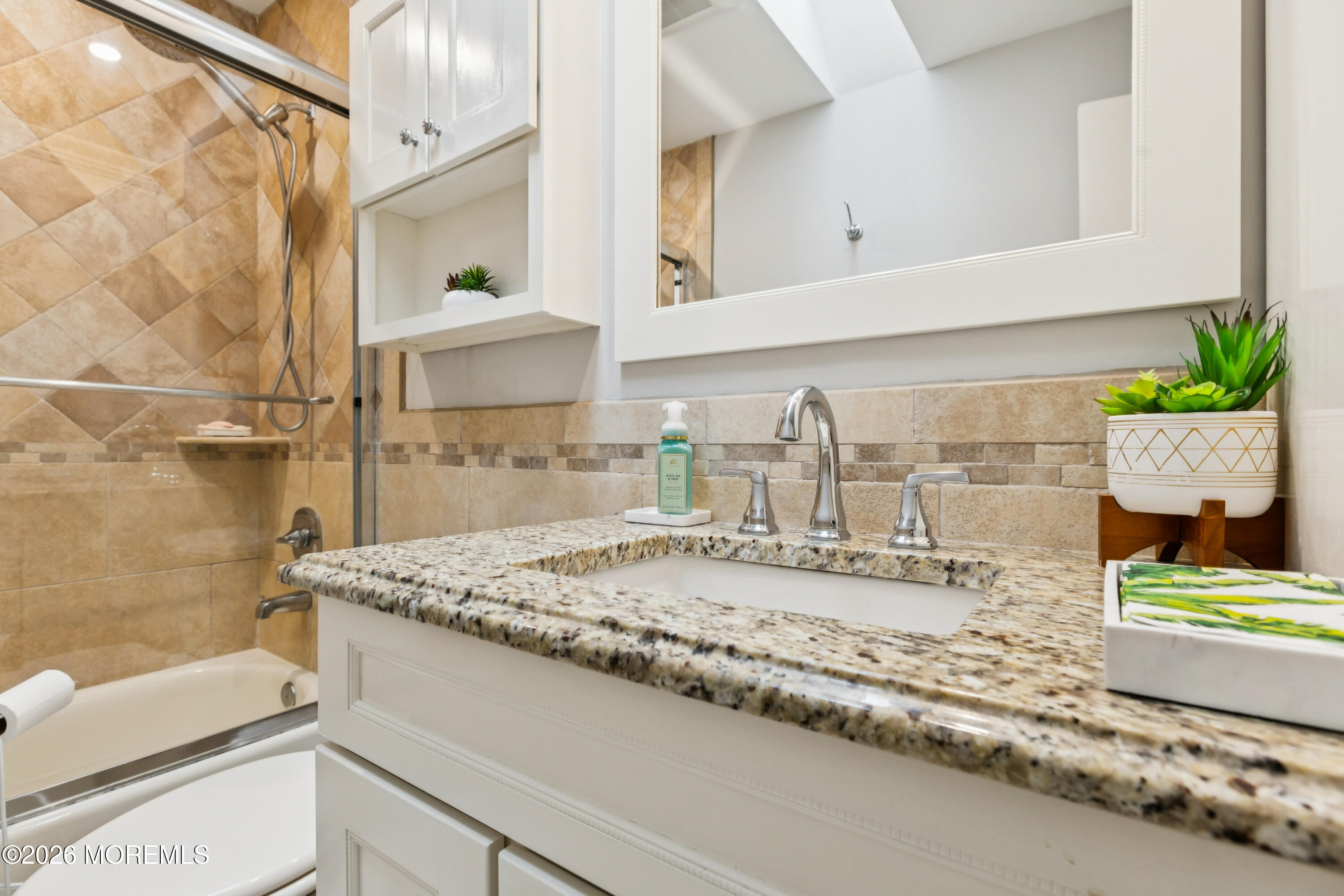 40 Pinyon Street Howell, NJ 07731 - Photo 11 of 29 a bathroom with a granite countertop sink and a mirror