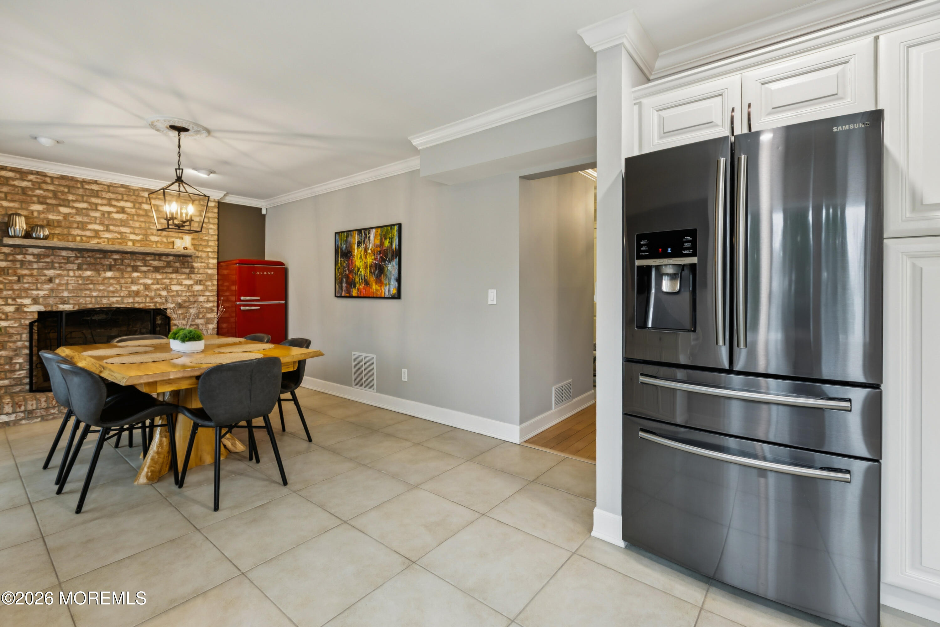 40 Pinyon Street Howell, NJ 07731 - Photo 6 of 29 a kitchen with stainless steel appliances a table chairs and refrigerator