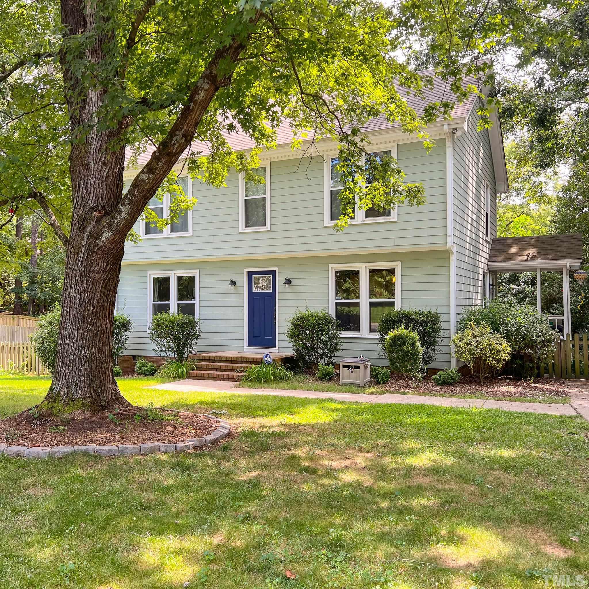 a view of a house with swimming pool and a yard