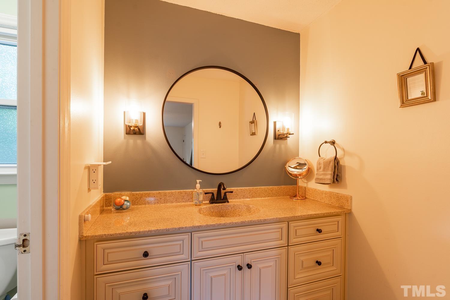 8112 Bentwood Place Raleigh, NC 27615 - Photo 13 of 24 a bathroom with a sink and a mirror