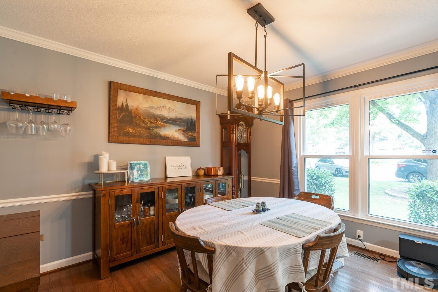 8112 Bentwood Place Raleigh, NC 27615 - Photo 16 of 24 a dining room with a large window table and chairs