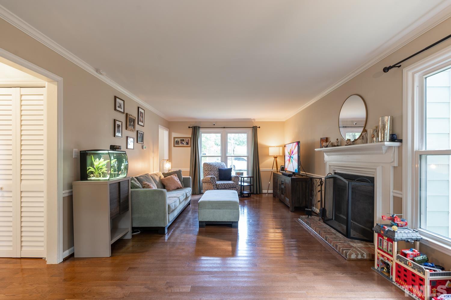 8112 Bentwood Place Raleigh, NC 27615 - Photo 21 of 24 a living room with furniture and a fireplace