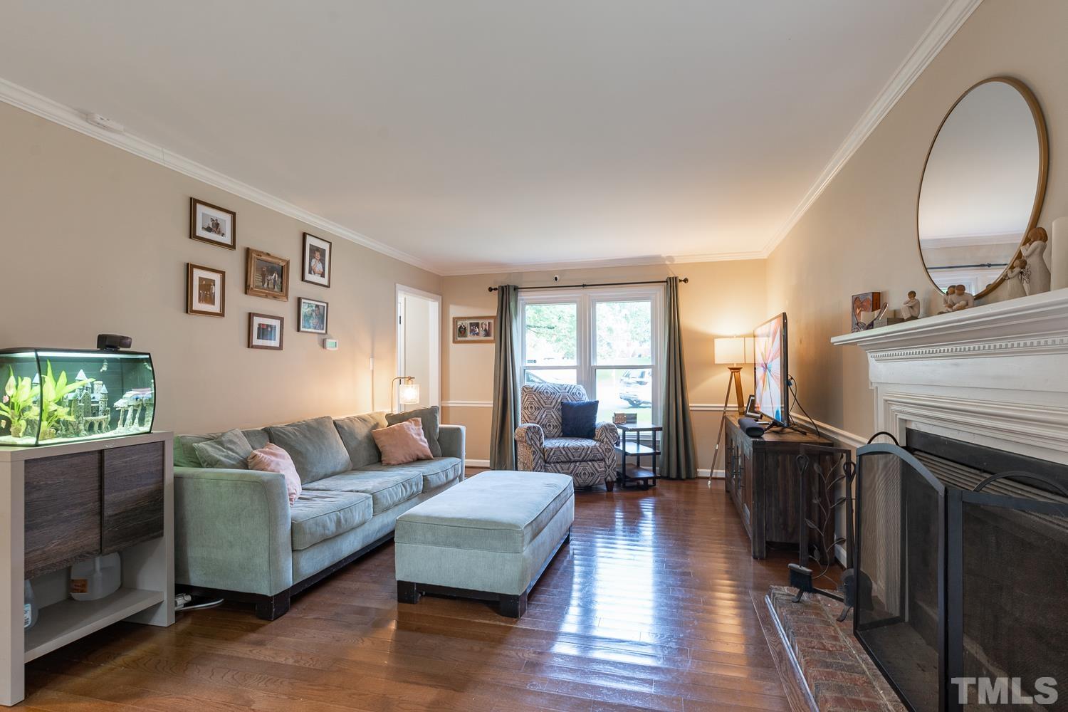 8112 Bentwood Place Raleigh, NC 27615 - Photo 22 of 24 a living room with furniture and wooden floor
