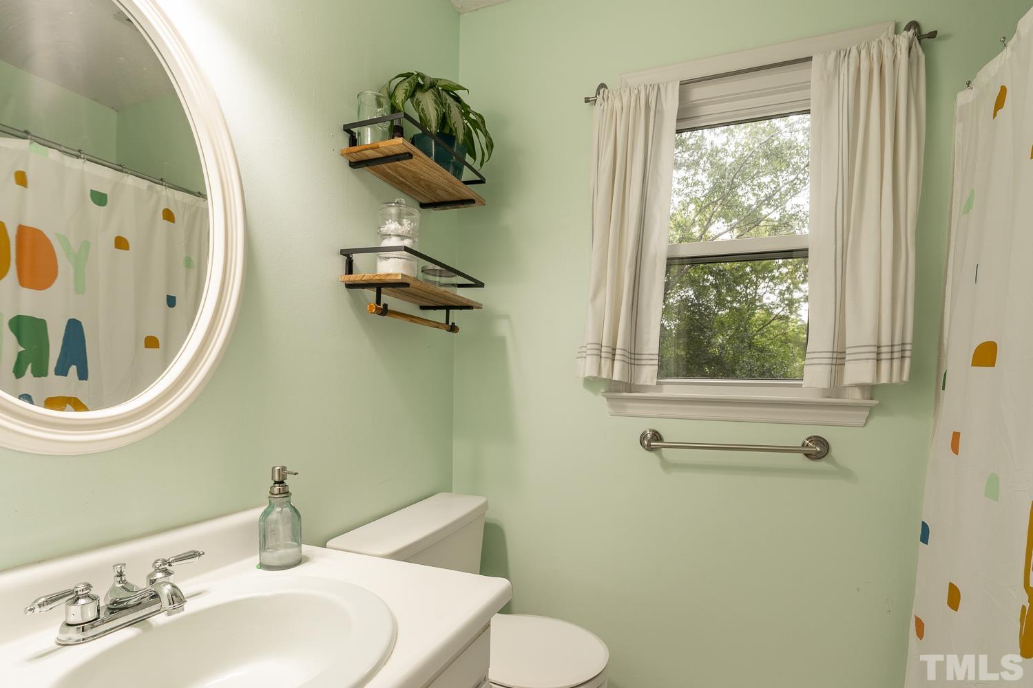 8112 Bentwood Place Raleigh, NC 27615 - Photo 9 of 24 a bathroom with a sink and mirror with toilet
