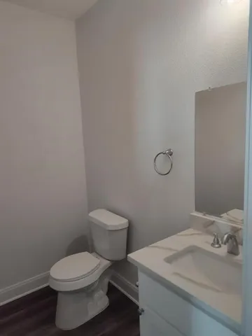 a white toilet sitting next to a bathroom sink