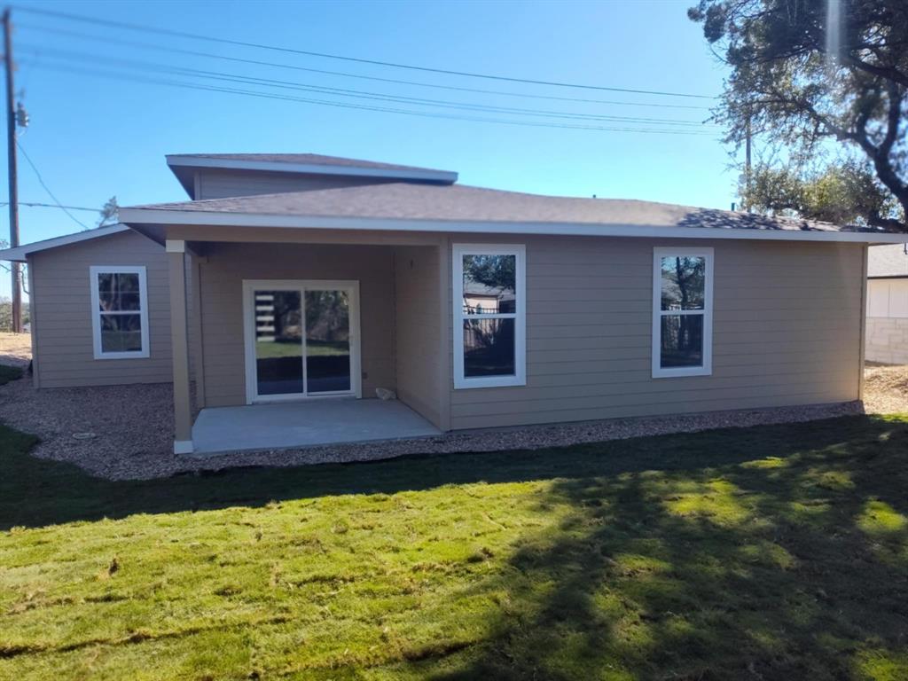 20008 Boggy Ford Road Lago Vista, TX 78645 - Photo 2 of 17 a front view of a house with a yard