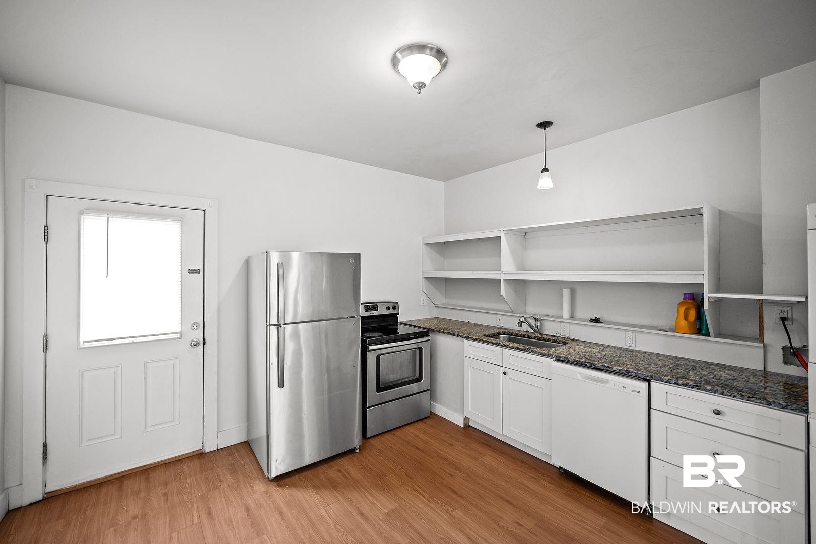 635 East Azalea Avenue Foley, AL 36535 - Photo 2 of 18 Kitchen featuring wood-finish flooring, white cabinetry, granite-style countertops, stainless steel appliances, and open shelving
