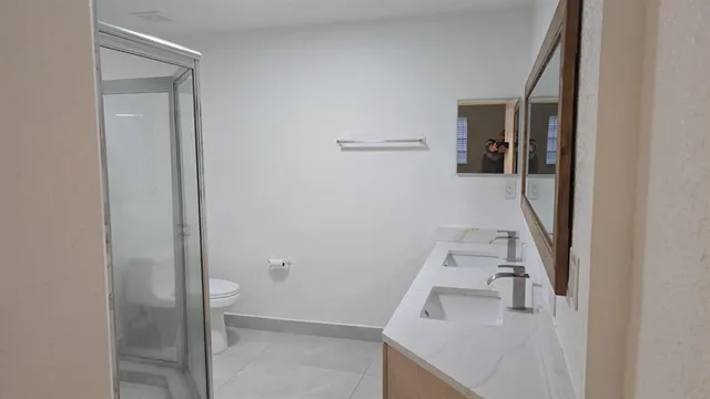 a bathroom with a shower and a toilet