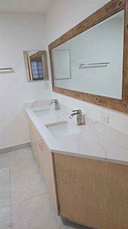 2801 Riverside Drive, Unit 104 Coral Springs, FL 33065 - Photo 12 of 22 a bathroom with a sink and a mirror